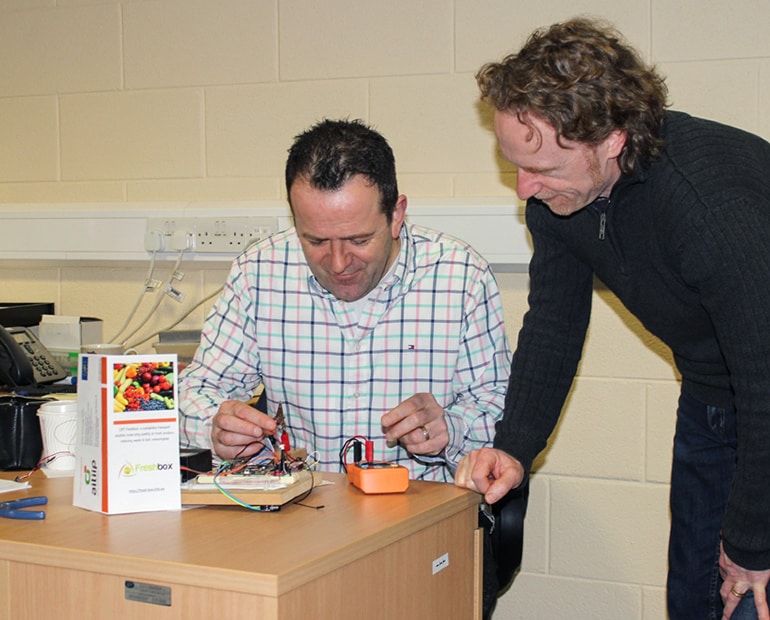 Two engineers working on prototype