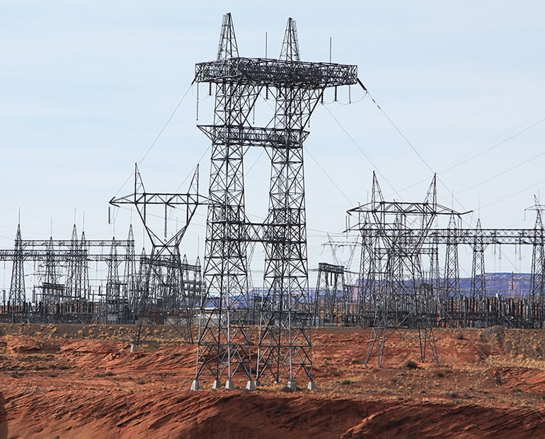 Group of power pylons in the desert 