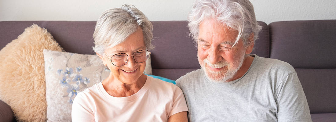 Elderly couple sitting on a sofa