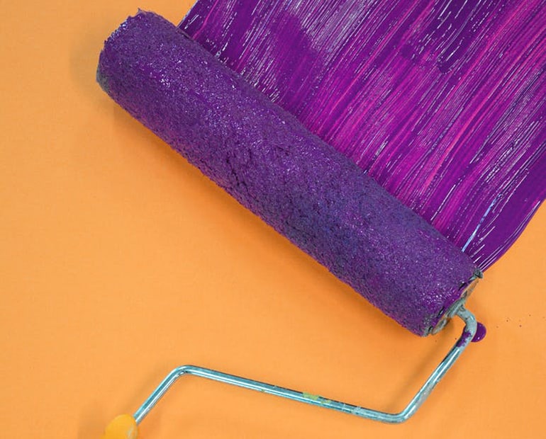 Paint roller with purple paint