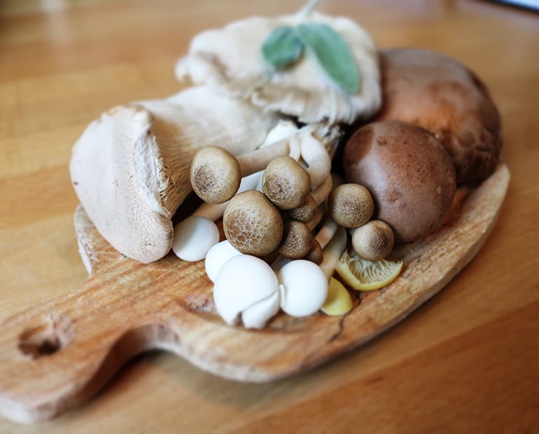 Selection of mushroom varieties on a wooden chopping board