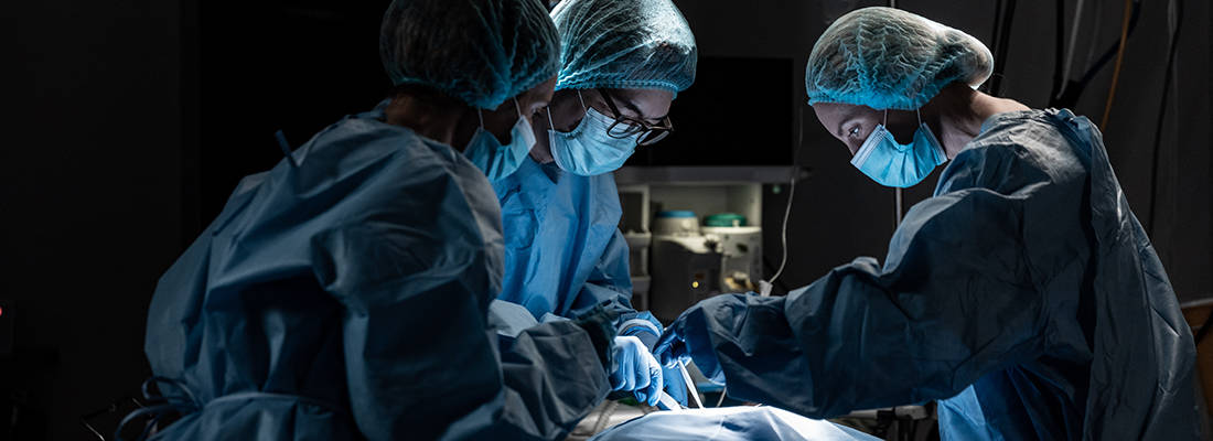 Three surgeons in an operating theatre 
