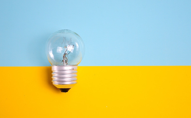Lightbulb on background of blue and yellow