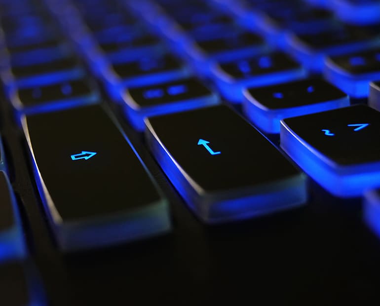 Close up of keyboard keys backlight in blue