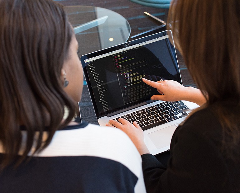 Two females looking at a laptop 