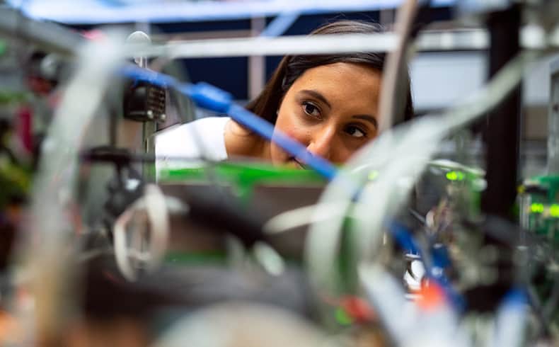 Female engineer looking through bundle of wires