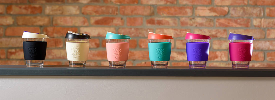 Six colourful monkey cups in a row