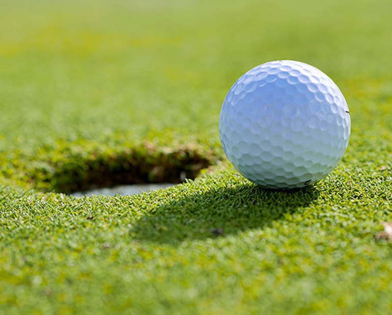 Close up of golf ball sitting on green