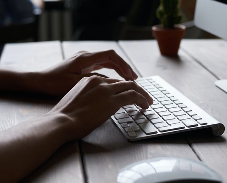 person typing on computer keyboard