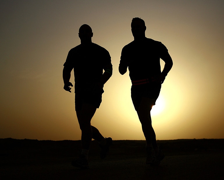 two runners at sunset