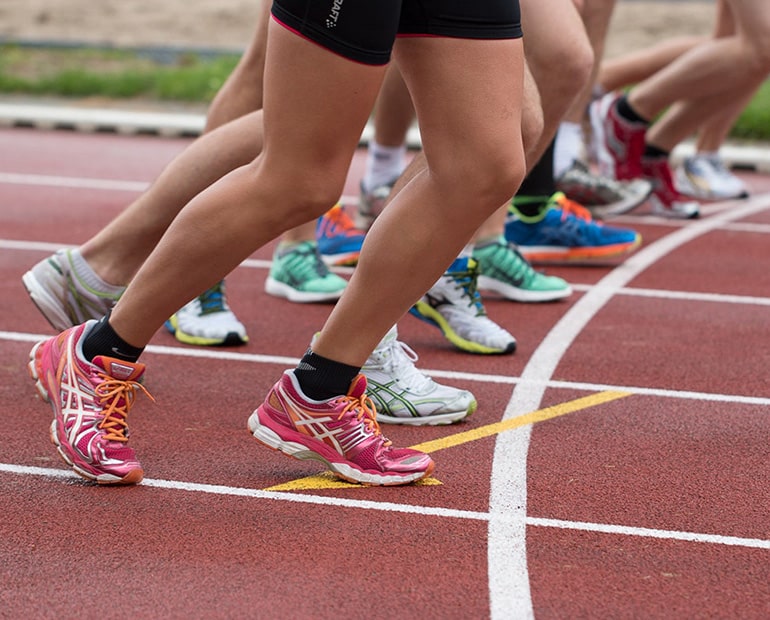 Close up of athletics on start line 