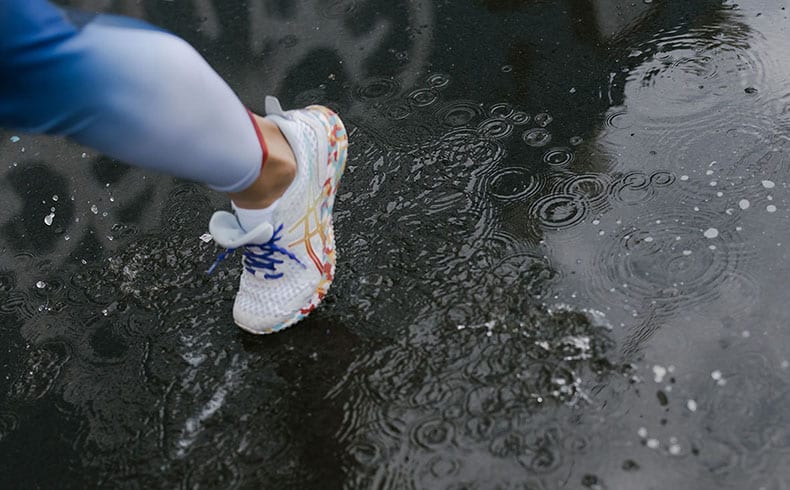 Female runner running in the rain