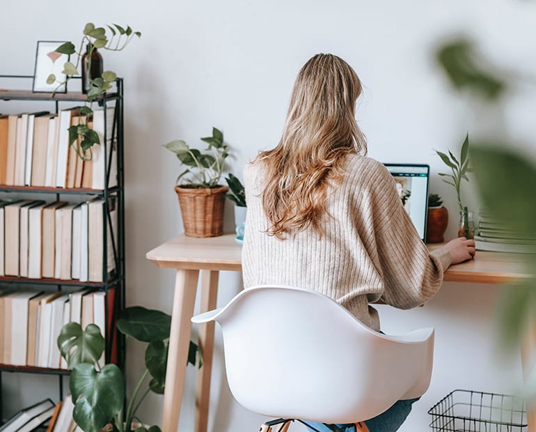 Woman sitting at desk using a laptop