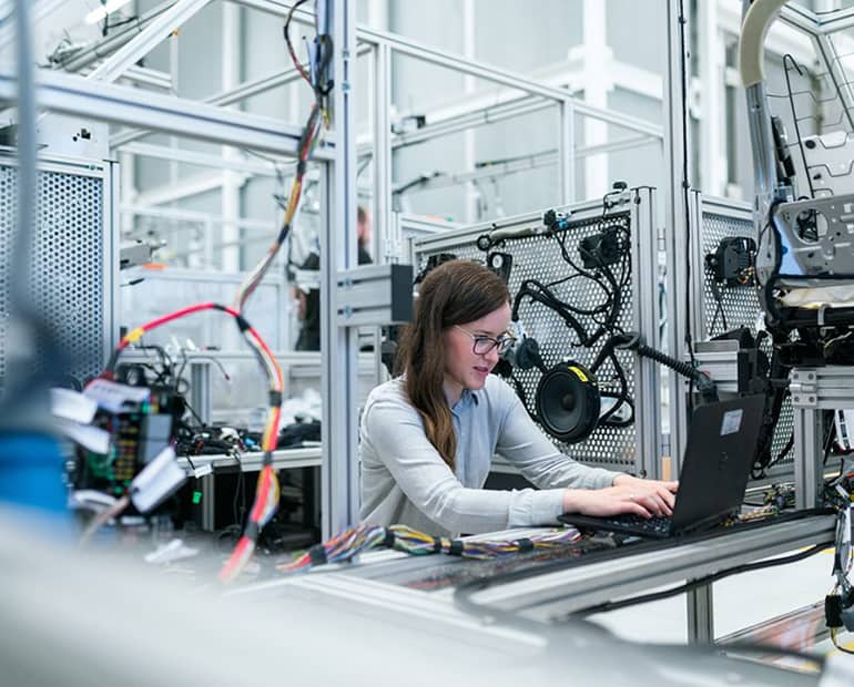 Female engineer working on a laptop in a lab 