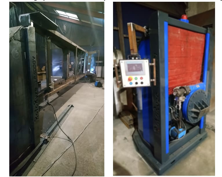 Large metal prototype with control panel sitting on factory floor