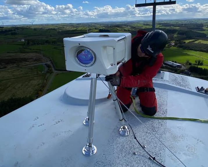 Engineer working on the top of a wind turbine