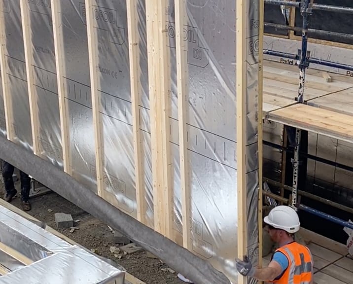 engineer moving a timber frame panel 