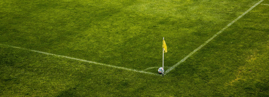 Soccer Ball on Side of Green Grass Field during Daytime

