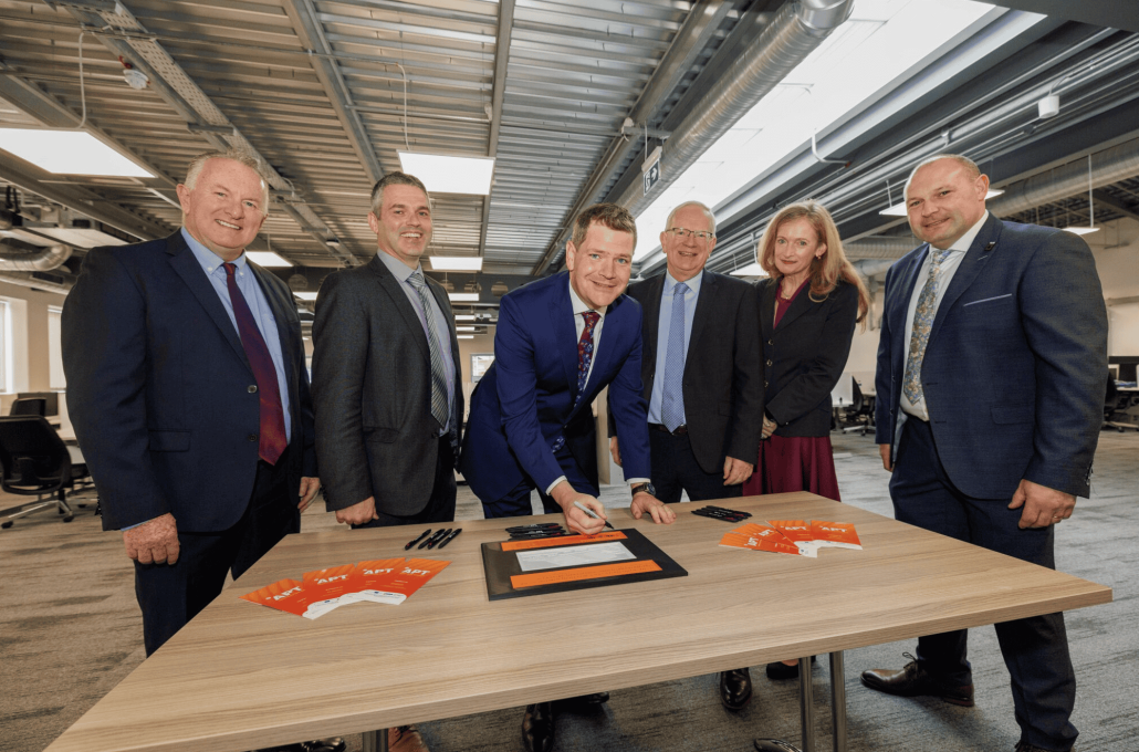 Minister Peter Burke signing a bespoke polymer print of the new APT facility in TUS Athlone