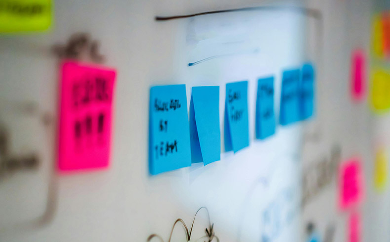Image of colourful Sticky Notes on white board