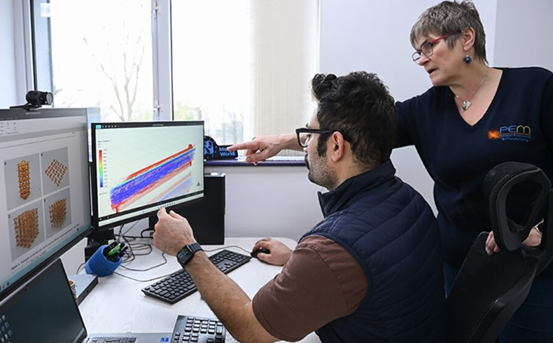 PEM team looking at computer screen
